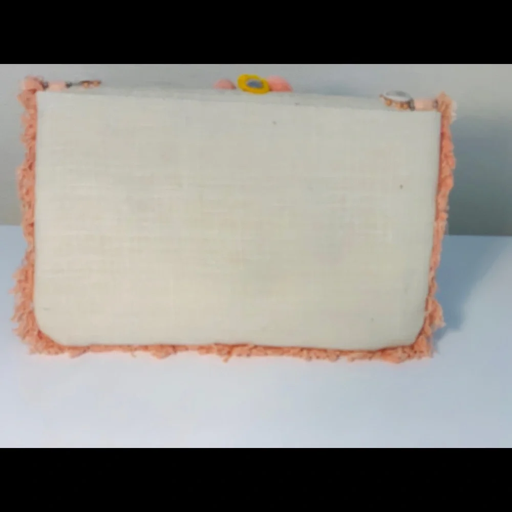 Canvas clutch with coral‎ and yellow pom-poms